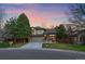 Charming two-story home with a well-manicured front yard, brick accents, and a two-car garage, set on a corner lot at 10240 Travertine Pl, Parker, CO 80134
