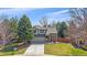 Charming two-story home featuring a brick facade, well-manicured lawn, and a welcoming porch swing at 10240 Travertine Pl, Parker, CO 80134