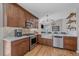 Modern kitchen with stainless steel appliances, marble countertops, and stylish wood cabinets at 10240 Travertine Pl, Parker, CO 80134