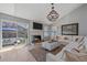 Inviting living room with fireplace, large windows, comfortable seating, and stylish decor at 10240 Travertine Pl, Parker, CO 80134
