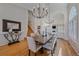Living and dining areas feature hardwood floors, large windows, stairs and decorative chandelier at 10240 Travertine Pl, Parker, CO 80134