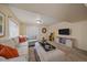 Inviting living room features a comfortable sectional couch, entertainment center, closet, and Pac-Personal arcade game at 10240 Travertine Pl, Parker, CO 80134