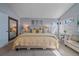 Well-lit main bedroom featuring a king-sized bed, ensuite access, and a serene atmosphere at 10240 Travertine Pl, Parker, CO 80134