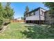 Large backyard with grass and a view of the rear of the house at 2043 S Salida St, Aurora, CO 80013