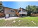 Home backyard featuring a mix of grass, patio, and elevated sun room at 2043 S Salida St, Aurora, CO 80013