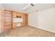 Finished basement area with built in shelves and carpet flooring at 2043 S Salida St, Aurora, CO 80013