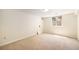 Finished basement area featuring a small window and carpet flooring at 2043 S Salida St, Aurora, CO 80013