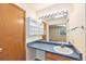 Well-lit bathroom with a large mirror, vanity, and an open view to the connected bedroom at 2043 S Salida St, Aurora, CO 80013