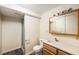 Bathroom with shower, toilet, sink and wood cabinet at 2043 S Salida St, Aurora, CO 80013