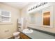 Cozy bathroom with classic sink, cabinet, and decorative mirror at 2043 S Salida St, Aurora, CO 80013