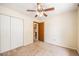 Cozy bedroom featuring a ceiling fan, closet, and neutral carpet flooring at 2043 S Salida St, Aurora, CO 80013