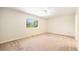 Bright bedroom with neutral carpet and a large window overlooking the backyard at 2043 S Salida St, Aurora, CO 80013