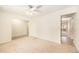 Spacious living room with neutral carpet, ceiling fan, and access to other parts of the house at 2043 S Salida St, Aurora, CO 80013