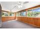 Bright sunroom with wood paneling, carpeted floor and many windows at 2043 S Salida St, Aurora, CO 80013