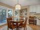 Bright breakfast nook features hardwood floors, round table, and sliding doors to a porch at 3810 E White Bay Dr, Highlands Ranch, CO 80126