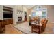 Cozy living room featuring a fireplace, built-in shelves, hardwood floors, and ample natural light at 3810 E White Bay Dr, Highlands Ranch, CO 80126