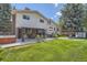 Expansive backyard with patio, hot tub, and lush green lawn, perfect for outdoor entertaining at 1011 S Holland Ct, Lakewood, CO 80226