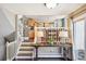 Inviting entryway featuring a console table, staircase to the left, and an open layout at 1011 S Holland Ct, Lakewood, CO 80226