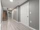 Basement hallway with a staircase, white trim, and sleek flooring at 1671 S Idalia Cir # D, Aurora, CO 80017