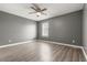 Spacious bedroom with wood-look floors, ceiling fan, and a window at 1671 S Idalia Cir # D, Aurora, CO 80017