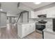 Beautiful kitchen with an island, white cabinets, and stainless steel appliances at 1671 S Idalia Cir # D, Aurora, CO 80017