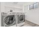 Bright laundry room equipped with a washer, dryer, and shelving at 1671 S Idalia Cir # D, Aurora, CO 80017