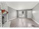 Bright living room featuring laminate flooring, a stone fireplace, and ample natural light at 1671 S Idalia Cir # D, Aurora, CO 80017