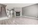 Spacious living room featuring laminate floors and a stunning stone fireplace at 1671 S Idalia Cir # D, Aurora, CO 80017