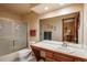 Clean bathroom with glass shower doors, toilet, sink, and large mirror at 7965 S Eudora Cir, Centennial, CO 80122