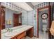 Blue-themed bathroom features a spacious vanity and framed round window in the shower at 7965 S Eudora Cir, Centennial, CO 80122