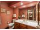 Traditional bathroom with dark wood vanity, decorative mirrors, and classic fixtures exudes warmth and charm at 7965 S Eudora Cir, Centennial, CO 80122