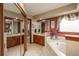 Bathroom featuring double sinks, soaking tub, walk-in shower, and mirrored closet doors at 7965 S Eudora Cir, Centennial, CO 80122