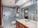 Stylish bathroom with unique blue tiled walls and a glass-enclosed shower at 7965 S Eudora Cir, Centennial, CO 80122