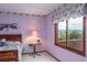 Inviting bedroom with a floral window valance and a peaceful, scenic view at 7965 S Eudora Cir, Centennial, CO 80122