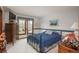 Comfortable bedroom featuring a blue bedspread, wooden furniture, and natural light at 7965 S Eudora Cir, Centennial, CO 80122
