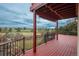 The outdoor deck features a painted red floor, black railings, and serene views of the adjacent golf course and blue skies at 7965 S Eudora Cir, Centennial, CO 80122