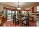Dining area features a glass-topped table and a view of the fireplace in the living room at 7965 S Eudora Cir, Centennial, CO 80122
