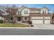 Charming two-story home features a brick facade, manicured lawn, and attached two car garage at 7965 S Eudora Cir, Centennial, CO 80122