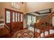 Inviting foyer with hardwood floors, a decorative rug, and a beautiful wood front door at 7965 S Eudora Cir, Centennial, CO 80122