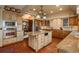 Open kitchen featuring stainless appliances, custom cabinets, and a large island at 7965 S Eudora Cir, Centennial, CO 80122