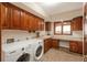 Functional laundry room with ample storage, modern appliances, and a built-in countertop for folding and sorting at 7965 S Eudora Cir, Centennial, CO 80122