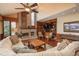 Comfortable living room with brick fireplace, built-in shelves, and plush seating, perfect for relaxation and entertainment at 7965 S Eudora Cir, Centennial, CO 80122