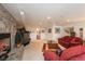This open basement living room features a stone fireplace and neutral decor at 7965 S Eudora Cir, Centennial, CO 80122