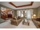 Comfortable living room featuring plush seating, large windows, and coffered ceiling at 7965 S Eudora Cir, Centennial, CO 80122