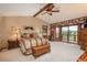 Spacious primary bedroom with vaulted ceilings, seating area, and large windows offering picturesque outdoor views at 7965 S Eudora Cir, Centennial, CO 80122