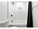 Newly renovated bathroom featuring white subway tile and modern black fixtures at 1941 Alton St, Aurora, CO 80010