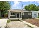 This cozy single-story home boasts an inviting entrance and a simple front yard with an extended driveway for easy access at 1941 Alton St, Aurora, CO 80010