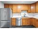 Kitchen features stainless steel appliances, updated countertops, and classic oak cabinets at 1941 Alton St, Aurora, CO 80010