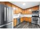 Charming kitchen with stainless steel appliances and beautiful oak cabinetry providing ample storage at 1941 Alton St, Aurora, CO 80010