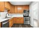 Well-lit kitchen features stainless steel appliances, oak cabinets and updated countertops at 1941 Alton St, Aurora, CO 80010